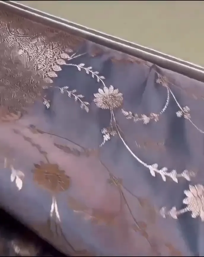 Video of the grey banarasi mashru silk jaal saree showing the drape and zari