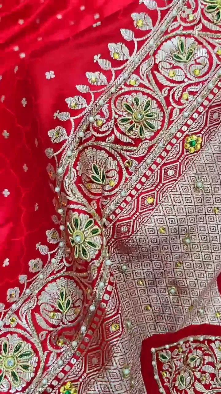 Video of the red with stonework banarasi mashru silk dardozi saree showing the drape and zari